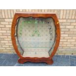 An Art Deco display cabinet with glass doors,
