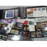 Philately - an album containing 30 UK first day covers and a collection of UK mint decimal postage