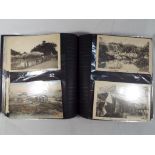 A modern photograph album containing approximately 200 postcards,