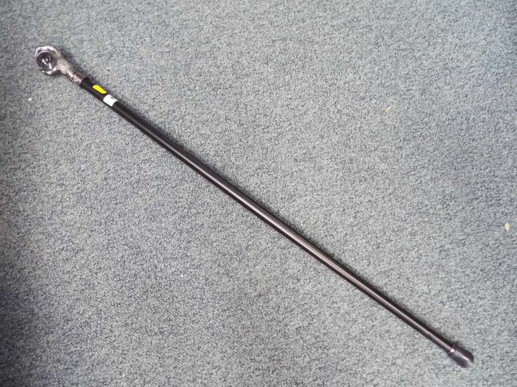 An unusual walking stick with a white me