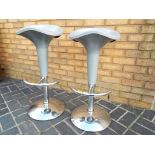 A pair of modern adjustable bar stools