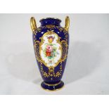 Minton - a twin-handled vase decorated w