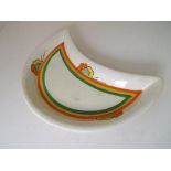 Clarice Cliff - a crescent shaped Honeyglaze dish hand painted in a floral design, 21.