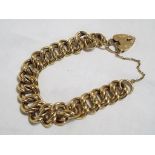 A hallmarked 9 carat gold bracelet with safety chain and hallmarked 9 carat gold padlock,