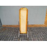 A retro style floor standing mirror frame on stand with castors.