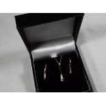 A 9 carat gold .20 pt diamond stick pendant and earrings set, (unused surplus retail stock) approx.