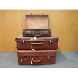 Three vintage leather suitcases