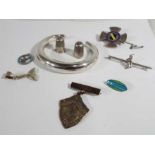 A collection of silver jewellery items to include two thimbles, enamel brooch, enamel charm, brooch,