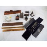 A wooden carving of a submarine, a writing / drawing set, a bottle of smelling salts,