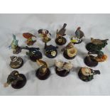 A collection of fifteen various bird figurines