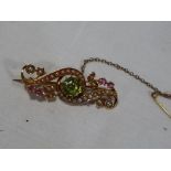 A lady's good quality 15 carat yellow gold bar brooch set with octagonal peridot,