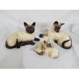 Royal Doulton - three Royal Doulton Siamese cats inscribed to the base with the model No.