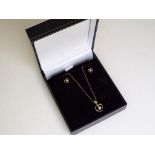 A lady's 9 carat gold cubic zirconia earring and pendant set,