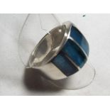 A lady's silver ring set with five blue panels,