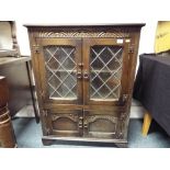 A priory style oak cupboard / display cabinet with astral glazed doors,