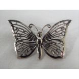 A silver brooch in the form of a butterfly stamped 925.