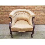 A Victorian mahogany upholstered tub chair.