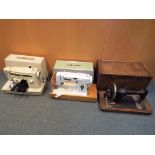 Two Singer sewing machine and a Roy Aitken deluxe sewing machine,