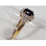 A lady's 9 carat gold black sapphire and diamond cluster ring,