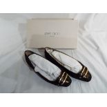 A pair of lady's slip on shoes in a bronze colour marked "Jimmy Choo" size 38,