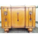 A solid oak 1920s carved fronted sideboard on pineapple supports 100 cm (h) x 130 cm x 51 cm.