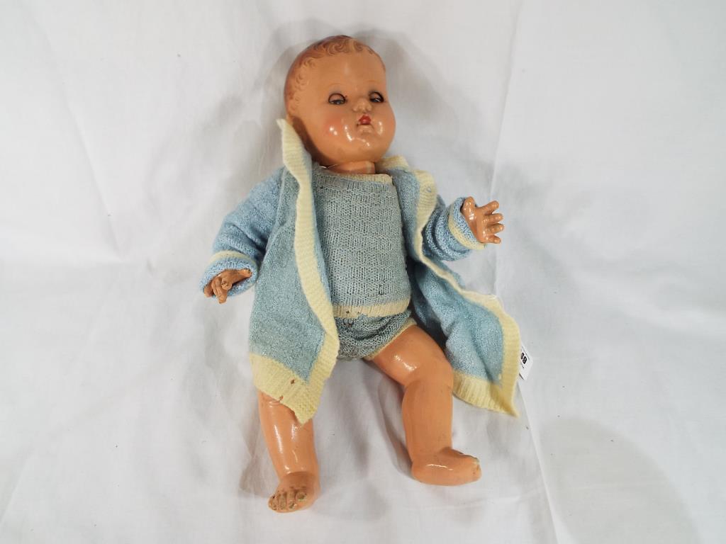 A mid 20th century dressed composition doll marked to the back of the neck 'BND London',