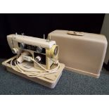 A New Home electric sewing machine with carry case