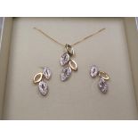 A 9 carat gold 20 pt diamond set leaf earrings and necklace set,