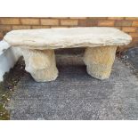 Stonework - a reconstituted stone garden bench with a tree stump design