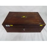 A vintage oak writing slope in black leather with brass corners containing two inkwells (one