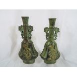 A pair of bronze Asian vases with gilded highlights, impressed marks to the base,