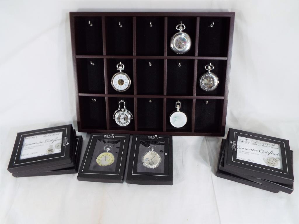 Thirteen silver plated pocket watches from the Heritage collection with display stand