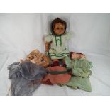 A mid 20th century dressed composition doll, sleeping eyes, open mouth, brown wig, jointed limbs,