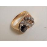(ex 556) A 14K yellow gold and black sapphire dress ring set with ten round single cut and