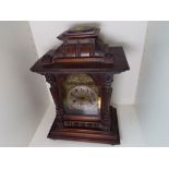 An early 20th century oak cased mantel clock striking on the hour and the half hour,