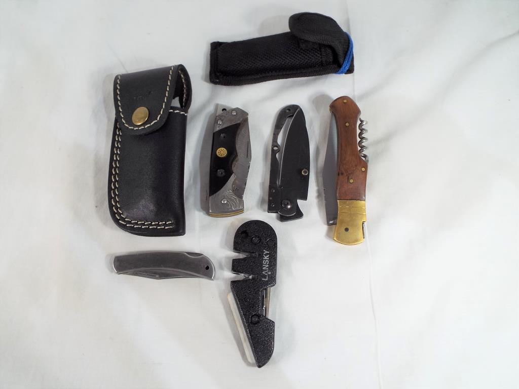 A collection of four knives comprising a Perkin Damascus steel folding knife in leather pouch /