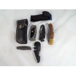A collection of four knives comprising a Perkin Damascus steel folding knife in leather pouch /