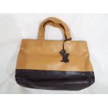 A lady's brown and tan handbag marked Radley,
