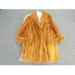 A good quality beaver fur coat with label reading Eatons Fur Salon,