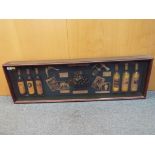 A glass fronted display cabinet depicting wines of the world,