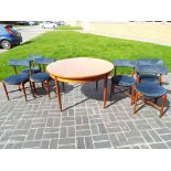 A good quality round extending dining table with six chairs by G-plan,
