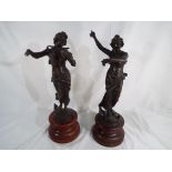 A pair of spelter figures depicting ladies on wooden plinths circa 1920s,