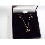 A lady's 9 carat gold cubic zirconia earring and pendant set,
