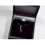 A 9 carat white gold pink sapphire drop pendant, (unused surplus retail stock) approx weight 1.