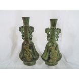 A pair of bronze Asian vases with gilded