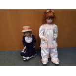 2 dress dolls on stands. One has a bisqu