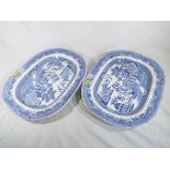 A pair of large blue and white "Willow Pattern" ashettes.