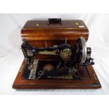 A good quality vintage sewing machine by "Jones's" in wooden carry case.