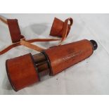 A brass telescope in a brown leather protective case Est £25 - £45