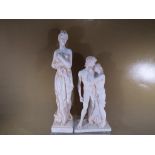 2 plaster figurines on plinths 46 cm and 34 cm (2)